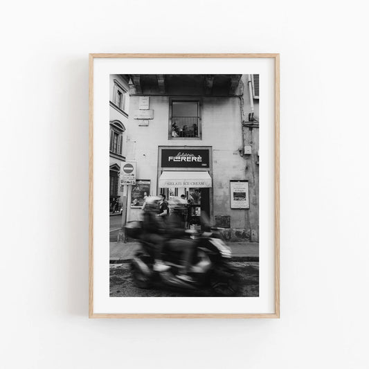 Black and white photography of a motorcycle blurred with speed in Florence, Italy.